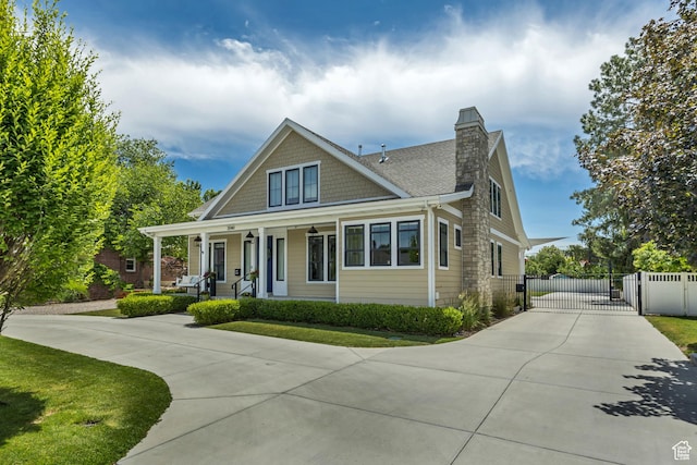 2040 E Lambourne Ave, Millcreek, UT 84109 - view of front facade featuring a gate, driveway, a porch, and a chimney