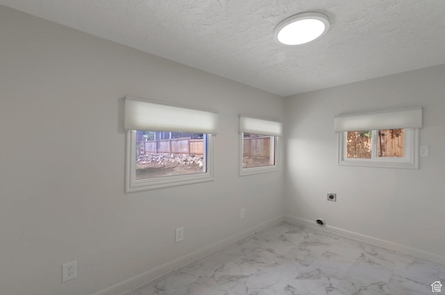 1540 23rd St, Ogden, UT 84401 - spare room with light marble finish floors and a textured ceiling