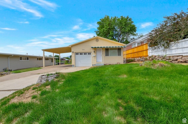1540 23rd St, Ogden, UT 84401 - view of front facade featuring concrete driveway, an attached carport, and an attached garage