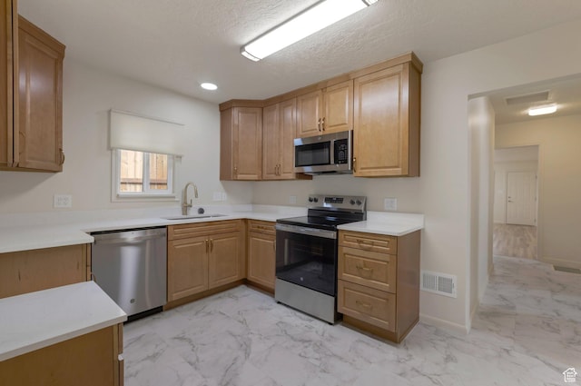 1540 23rd St, Ogden, UT 84401 - kitchen featuring appliances with stainless steel finishes, light marble finish flooring, light countertops, and recessed lighting