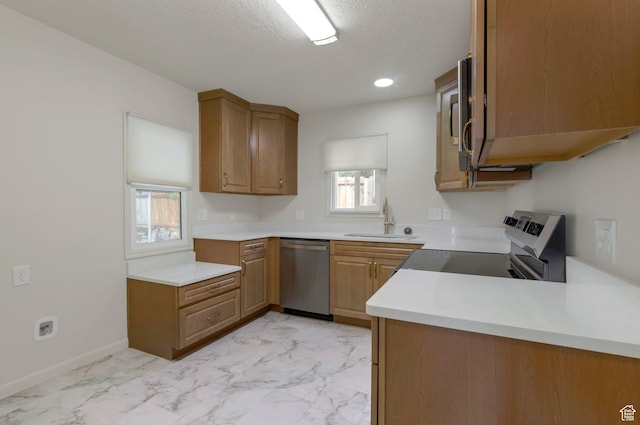 1540 23rd St, Ogden, UT 84401 - kitchen featuring stainless steel dishwasher, light marble finish floors, light countertops, a textured ceiling, and range with electric cooktop
