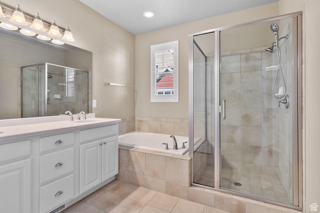 4892 W Veeroma Way S, Jordan, UT 84009 - bathroom with double vanity, a stall shower, a garden tub, tile patterned flooring, and recessed lighting