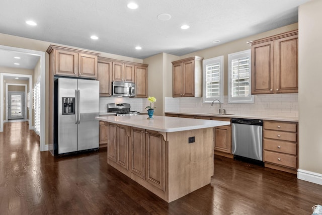 4892 W Veeroma Way S, Jordan, UT 84009 - kitchen featuring appliances with stainless steel finishes, a kitchen island, dark wood-type flooring, backsplash, and light countertops