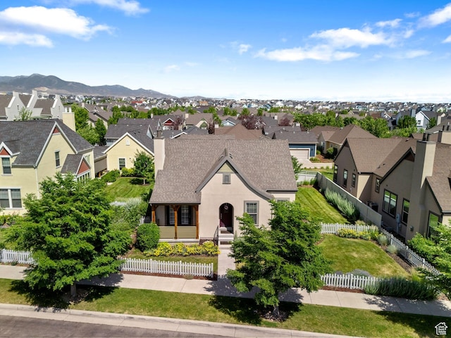 4892 W Veeroma Way S, Jordan, UT 84009 - french country home with a residential view, a shingled roof, a fenced front yard, a mountain view, and a chimney