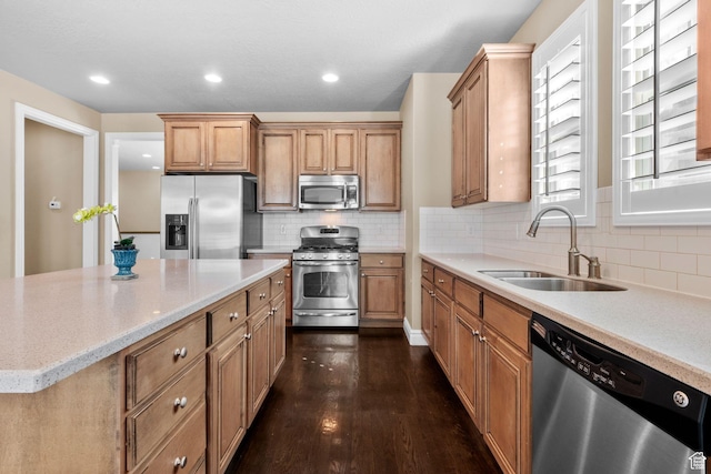 4892 W Veeroma Way S, Jordan, UT 84009 - kitchen with appliances with stainless steel finishes, tasteful backsplash, dark wood-style floors, and light stone counters