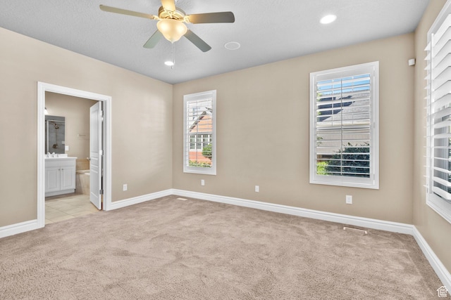 4892 W Veeroma Way S, Jordan, UT 84009 - unfurnished bedroom with light colored carpet, a ceiling fan, connected bathroom, and recessed lighting