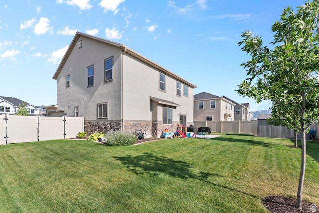 231 N 750 W, Springville, UT 84663 - rear view of property featuring stone siding, a gate, a fenced backyard, and stucco siding