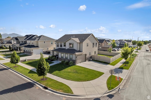 231 N 750 W, Springville, UT 84663 - view of front facade with a garage, a residential view, concrete driveway, and stone siding