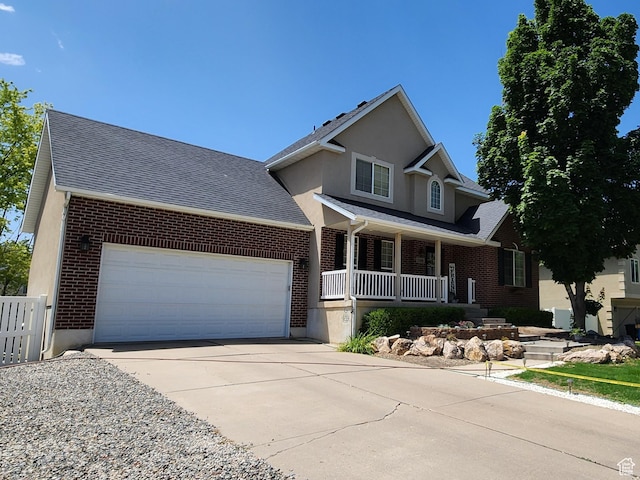 1309 W 1200 S, Woods Cross, UT 84087 - traditional home featuring covered porch, brick siding, an attached garage, concrete driveway, and a shingled roof