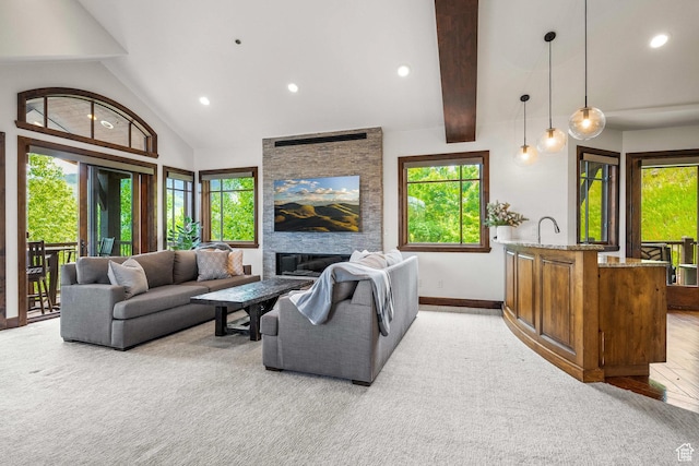4121 Fairway Ln Unit A1, Park City, UT 84098 - living area featuring light colored carpet, recessed lighting, a stone fireplace, beamed ceiling, and high vaulted ceiling