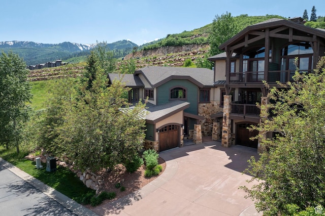 4121 Fairway Ln Unit A1, Park City, UT 84098 - view of front of property with stone siding, a balcony, a garage, concrete driveway, and stucco siding