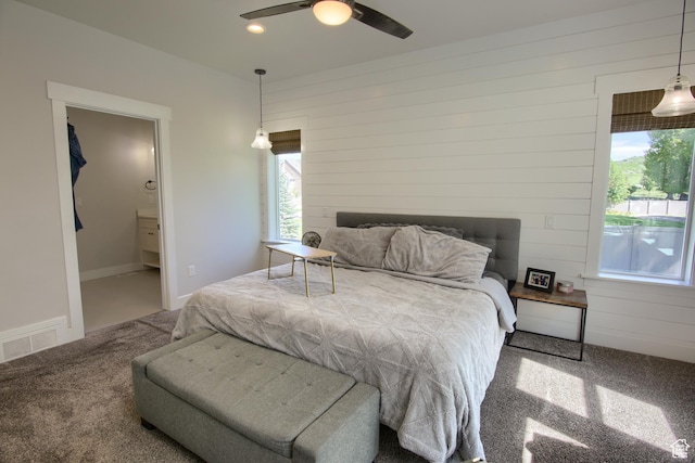 6038 N Hidden Valley Rd Unit 319, Mountain Green, UT 84050 - bedroom featuring carpet floors, wooden walls, multiple windows, ceiling fan, and connected bathroom