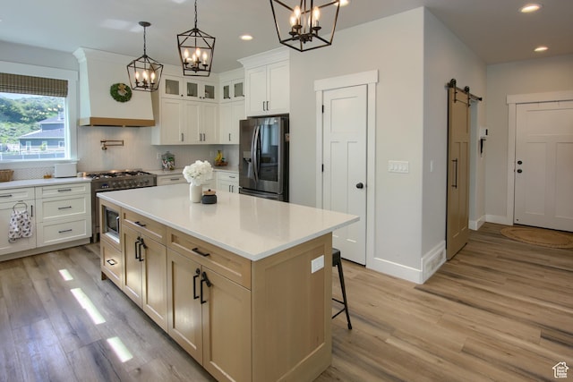 6038 N Hidden Valley Rd Unit 319, Mountain Green, UT 84050 - kitchen featuring appliances with stainless steel finishes, a chandelier, recessed lighting, light wood-style floors, and a barn door