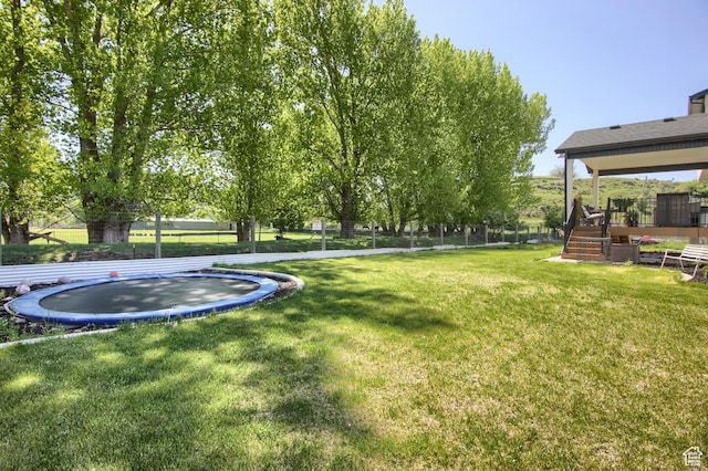 6038 N Hidden Valley Rd Unit 319, Mountain Green, UT 84050 - view of yard featuring a trampoline, a deck, and stairs