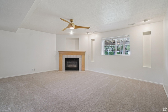 4964 Boulder Glen Cir, West Jordan, UT 84088 - unfurnished living room featuring ceiling fan, a tile fireplace, carpet floors, and a textured ceiling