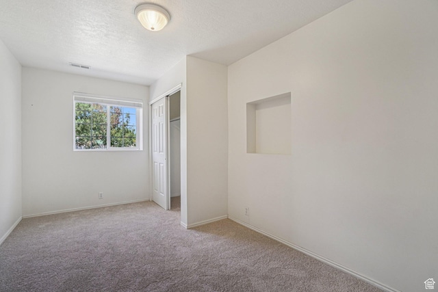 4964 Boulder Glen Cir, West Jordan, UT 84088 - unfurnished bedroom featuring carpet flooring, a closet, and a textured ceiling