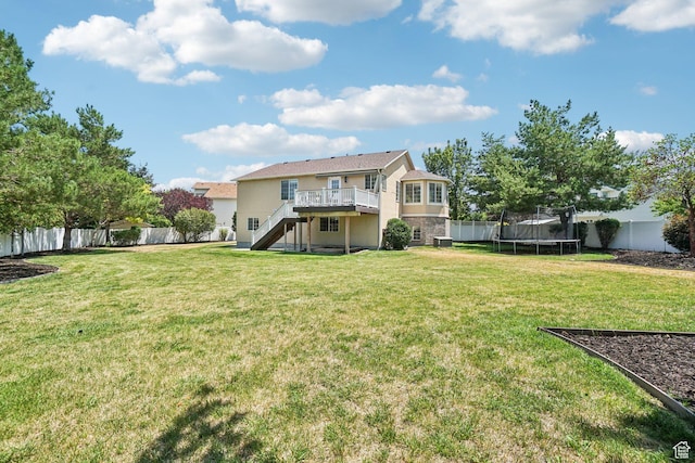 4964 Boulder Glen Cir, West Jordan, UT 84088 - rear view of house featuring stairway, a trampoline, a fenced backyard, a wooden deck, and stucco siding
