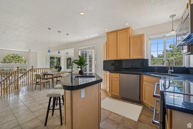 4964 Boulder Glen Cir, West Jordan, UT 84088 - kitchen featuring stainless steel dishwasher, a textured ceiling, healthy amount of natural light, tasteful backsplash, and light tile patterned flooring