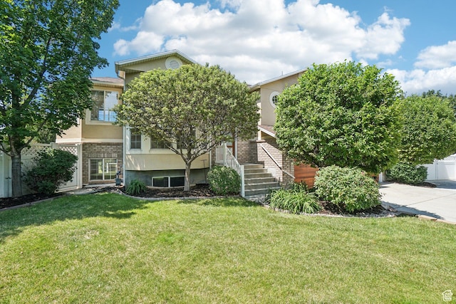 4964 Boulder Glen Cir, West Jordan, UT 84088 - view of property hidden behind natural elements featuring stucco siding