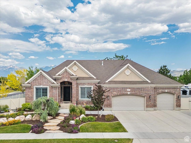 12937 S Old Country Ct W, Riverton, UT 84065 - view of front facade featuring an attached garage, driveway, brick siding, and stucco siding