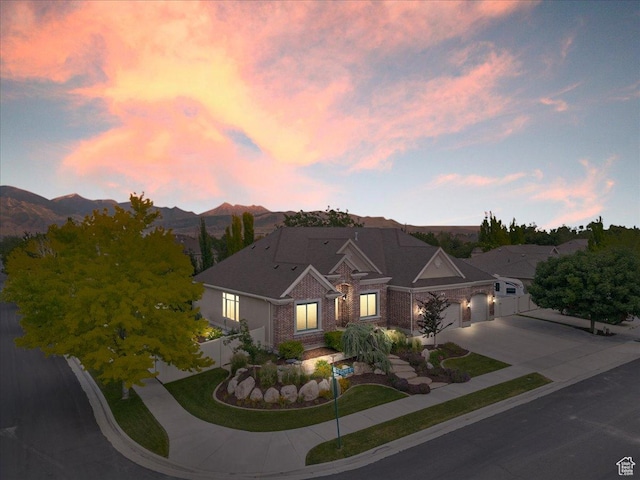 12937 S Old Country Ct W, Riverton, UT 84065 - view of front of house featuring driveway, an attached garage, a mountain view, and brick siding