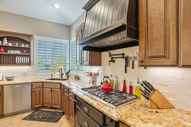 12937 S Old Country Ct W, Riverton, UT 84065 - kitchen with stainless steel appliances, custom exhaust hood, tasteful backsplash, light stone countertops, and brown cabinetry