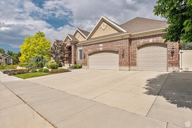 12937 S Old Country Ct W, Riverton, UT 84065 - view of front of home with concrete driveway, a garage, brick siding, and roof with shingles