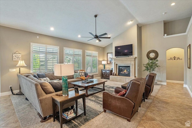 12937 S Old Country Ct W, Riverton, UT 84065 - living room with arched walkways, ceiling fan, a tiled fireplace, light tile patterned flooring, and recessed lighting