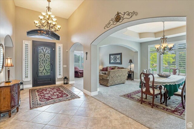 12937 S Old Country Ct W, Riverton, UT 84065 - entryway with a chandelier, healthy amount of natural light, carpet flooring, and arched walkways