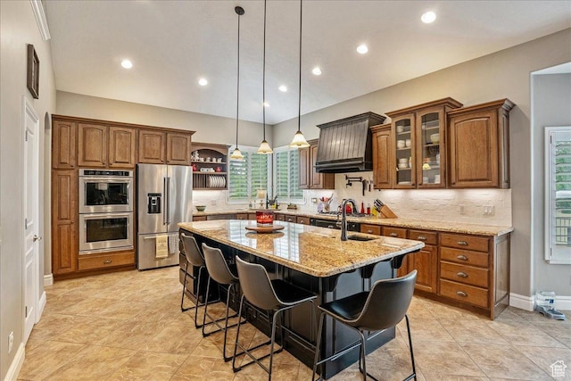 12937 S Old Country Ct W, Riverton, UT 84065 - kitchen featuring appliances with stainless steel finishes, a center island with sink, brown cabinets, open shelves, and recessed lighting