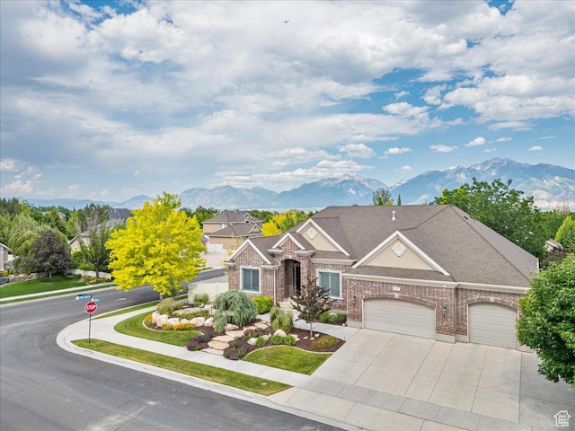 12937 S Old Country Ct W, Riverton, UT 84065 - traditional-style house featuring a mountain view, brick siding, an attached garage, and concrete driveway