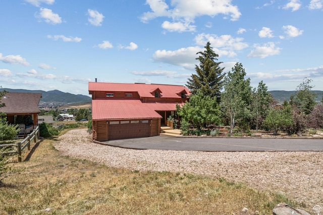 6385 Mountain View Dr, Park City, UT 84098 - view of front of home featuring driveway, a mountain view, a metal roof, and an attached garage