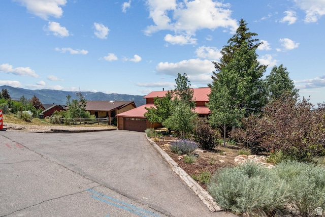 6385 Mountain View Dr, Park City, UT 84098 - view of front of home featuring a garage, driveway, a mountain view, and a metal roof