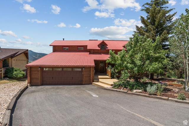 6385 Mountain View Dr, Park City, UT 84098 - log-style house with log exterior, driveway, a metal roof, and an attached garage