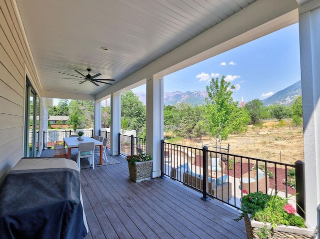 7817 S Danish Pine Ln Unit 101, Cottonwood Heights, UT 84121 - wooden terrace with outdoor dining area, a mountain view, ceiling fan, and grilling area