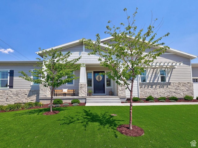 7817 S Danish Pine Ln Unit 101, Cottonwood Heights, UT 84121 - craftsman-style home with stone siding, a front lawn, and a porch