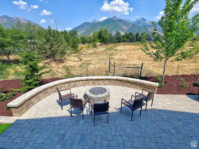 7817 S Danish Pine Ln Unit 101, Cottonwood Heights, UT 84121 - view of patio featuring an outdoor fire pit and a mountain view