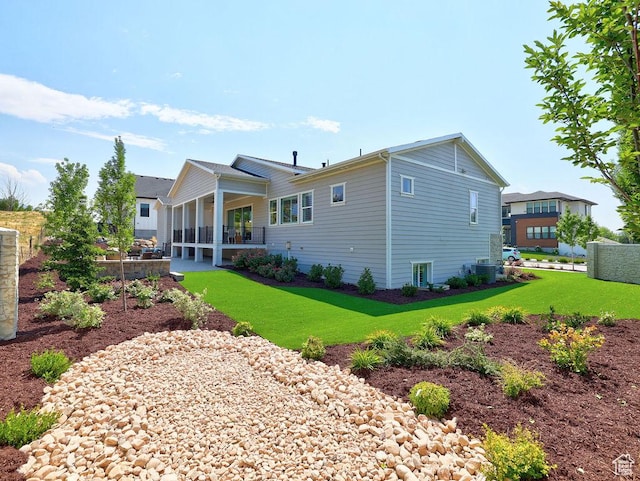 7817 S Danish Pine Ln Unit 101, Cottonwood Heights, UT 84121 - rear view of property featuring a lawn and a patio