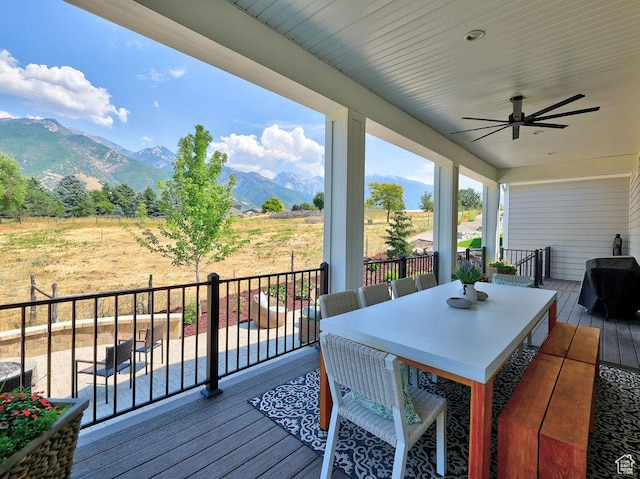 7817 S Danish Pine Ln Unit 101, Cottonwood Heights, UT 84121 - wooden deck featuring a mountain view, ceiling fan, outdoor dining area, and grilling area