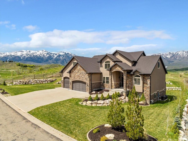 6167 N Hidden Hills Dr, Mountain Green, UT 84050 - french country style house with stone siding, a garage, driveway, and a mountain view