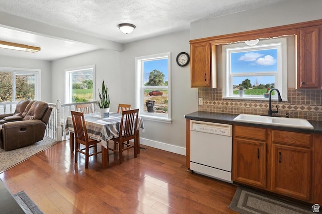 11395 N 4400 W, Tremonton, UT 84337 - kitchen featuring white dishwasher, tasteful backsplash, dark countertops, dark wood finished floors, and a textured ceiling