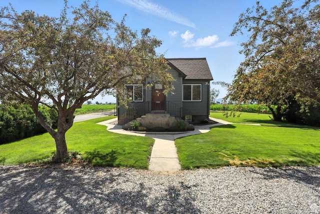 11395 N 4400 W, Tremonton, UT 84337 - view of front facade with a front yard and a shingled roof