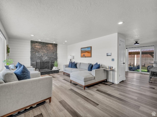 4332 W Losee Dr, West Valley City, UT 84120 - living area featuring a textured ceiling, wood finished floors, recessed lighting, and a fireplace