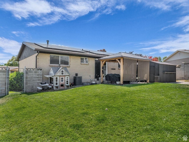 4332 W Losee Dr, West Valley City, UT 84120 - back of house with a gazebo, brick siding, and roof mounted solar panels