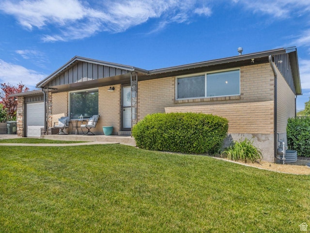 4332 W Losee Dr, West Valley City, UT 84120 - ranch-style home with brick siding, board and batten siding, an attached garage, and a front lawn