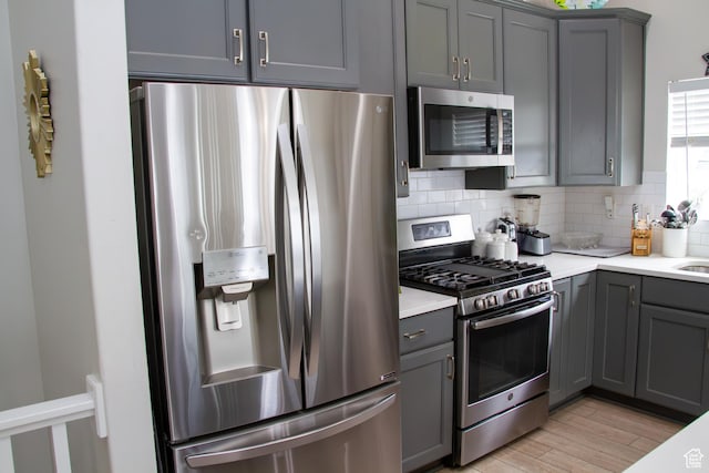 1415 N 3300 W, Provo, UT 84601 - kitchen featuring stainless steel appliances, gray cabinets, tasteful backsplash, and light countertops
