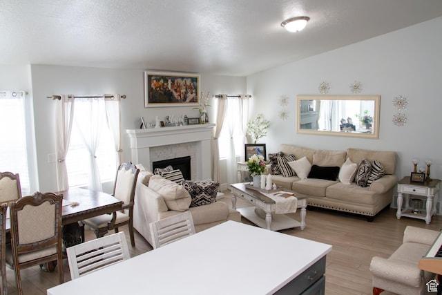 1415 N 3300 W, Provo, UT 84601 - living area with healthy amount of natural light, wood finished floors, a fireplace, and a textured ceiling
