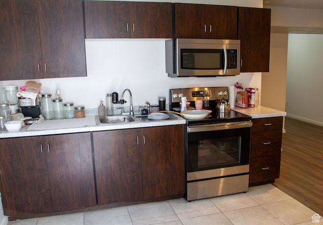 1415 N 3300 W, Provo, UT 84601 - kitchen featuring stainless steel appliances, light countertops, dark brown cabinetry, and light tile patterned flooring