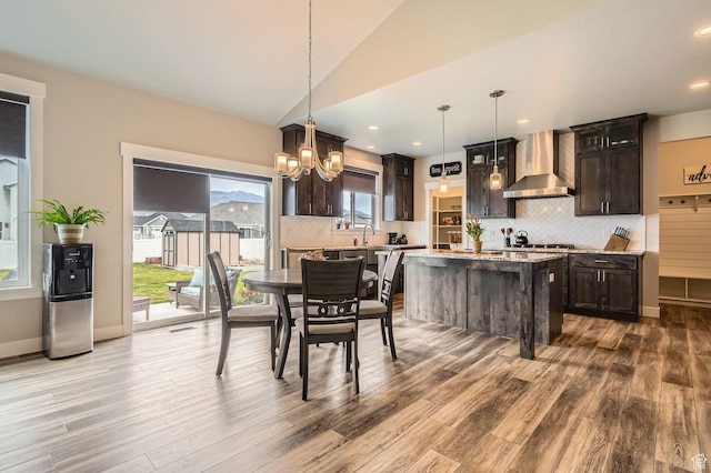 4909 N Cliffrose Dr, Eagle Mountain, UT 84005 - dining area with wood finished floors, a chandelier, lofted ceiling, and recessed lighting