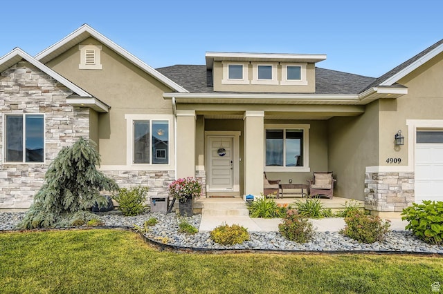 4909 N Cliffrose Dr, Eagle Mountain, UT 84005 - doorway to property featuring stone siding, stucco siding, and a porch